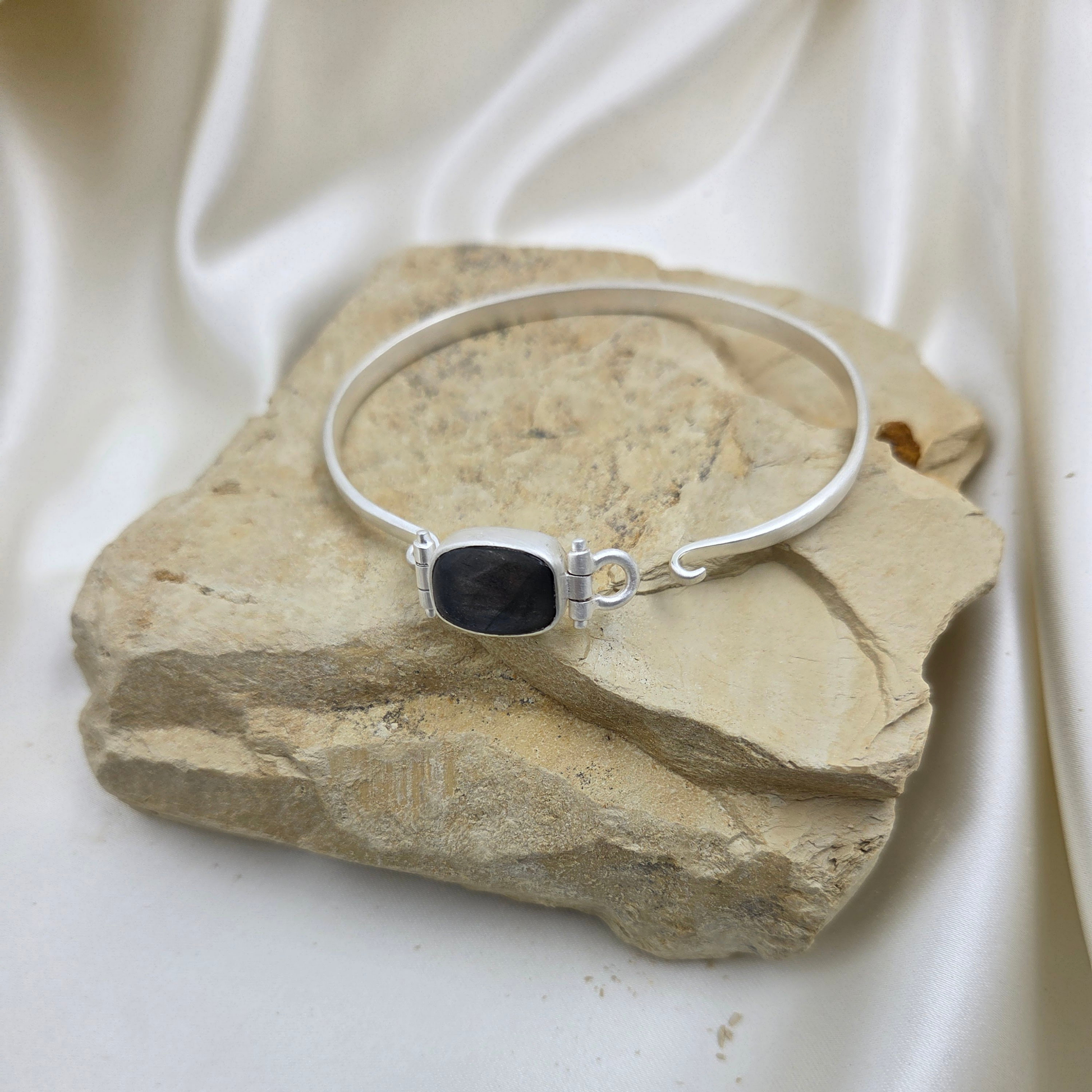 Silver bracelet with a blue stone flat